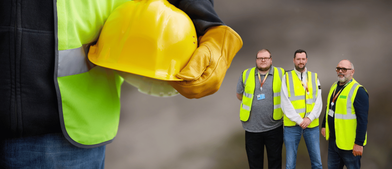 three lsbtc staff members in front of a background of a construction worker holding a safety helmet